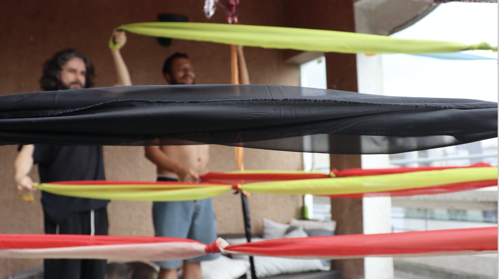 Pictures of the performance Body-Weave , conceptualized by artist Alexandre Heberte , in which we had to use our bodies in a synchronized choreography to collectively weave stripes of fabric, creating a piece that could intertwine our individual p