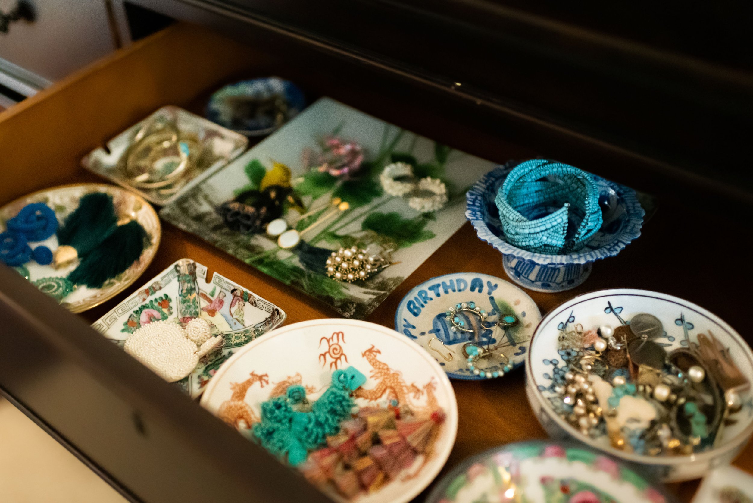 Organized Jewelry inside small dishes inside a drawer