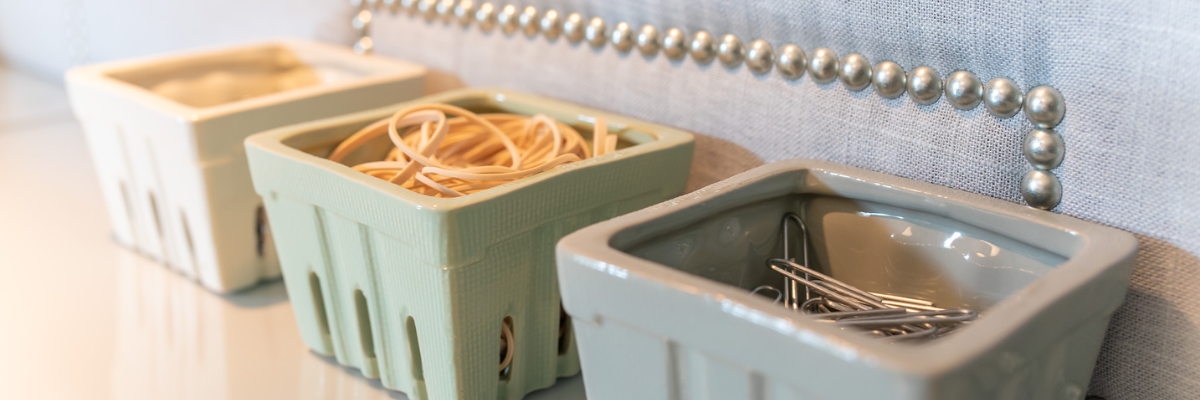 organized desk - small containers holding rubber bands & paperclips.png