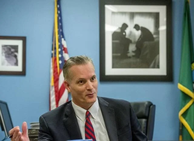 Pierce County Prosecutor Mark Lindquist, racist suspect in photo above, concluded the shooting was lawful and determined the SWAT sniper "did what was necessary to protect a child."