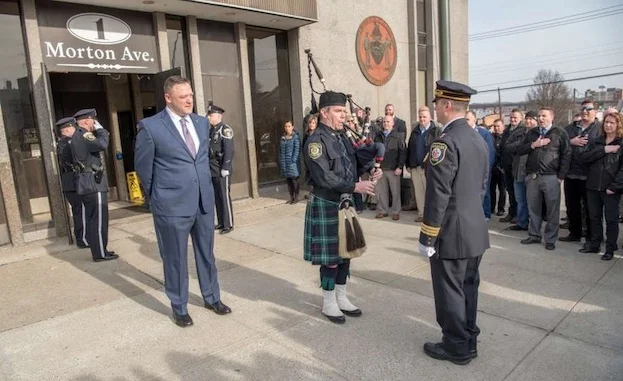 Albany Police Detective James Olsen stands outside South Station for a tradition piping out ceremony to mark his retirement on Jan. 4, 2018, in Albany, N.Y.
