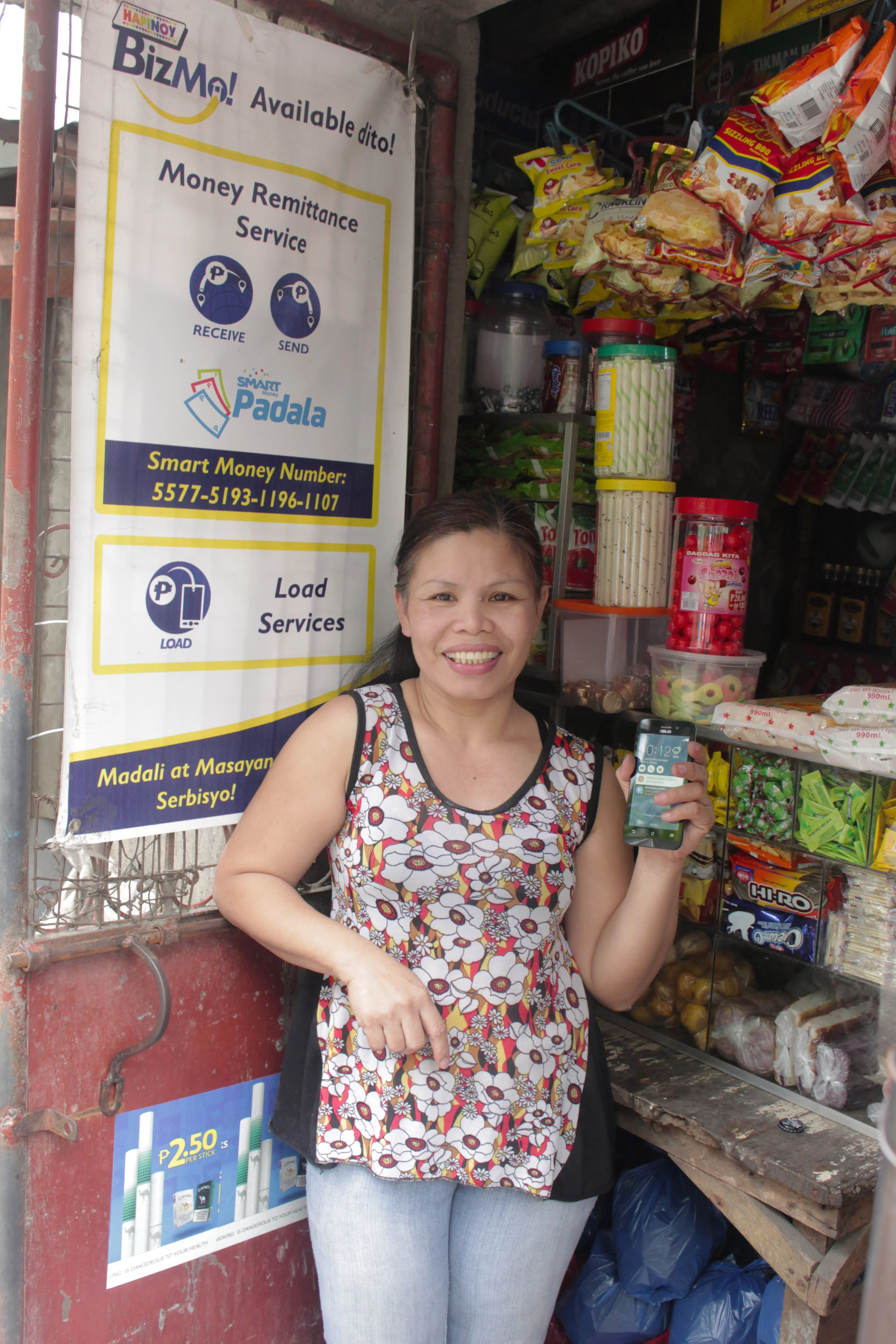 Tita Emily Ebias poses with her Hapinoy BizMo.