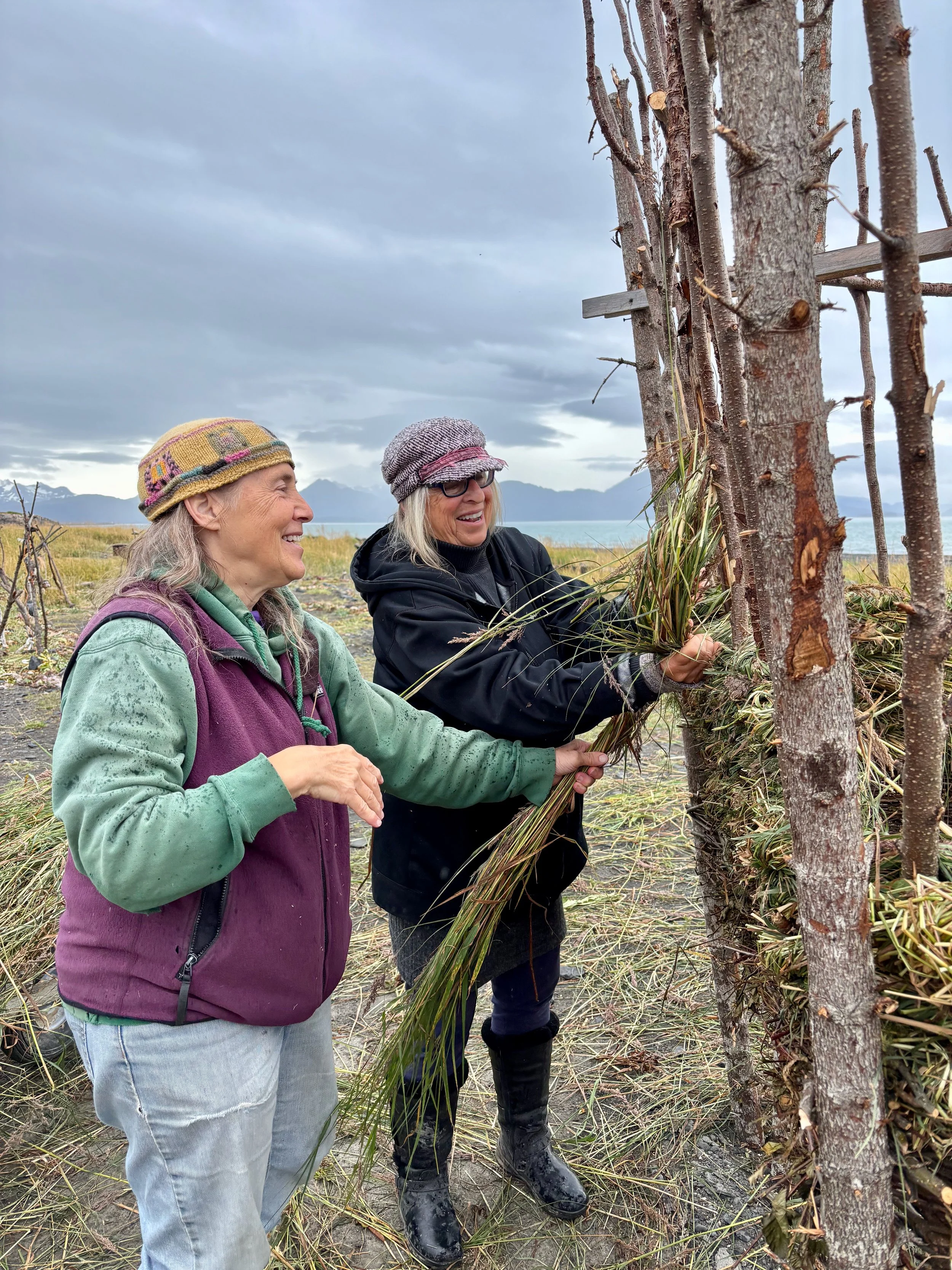 Mavis weaving with friend and smile.jpeg