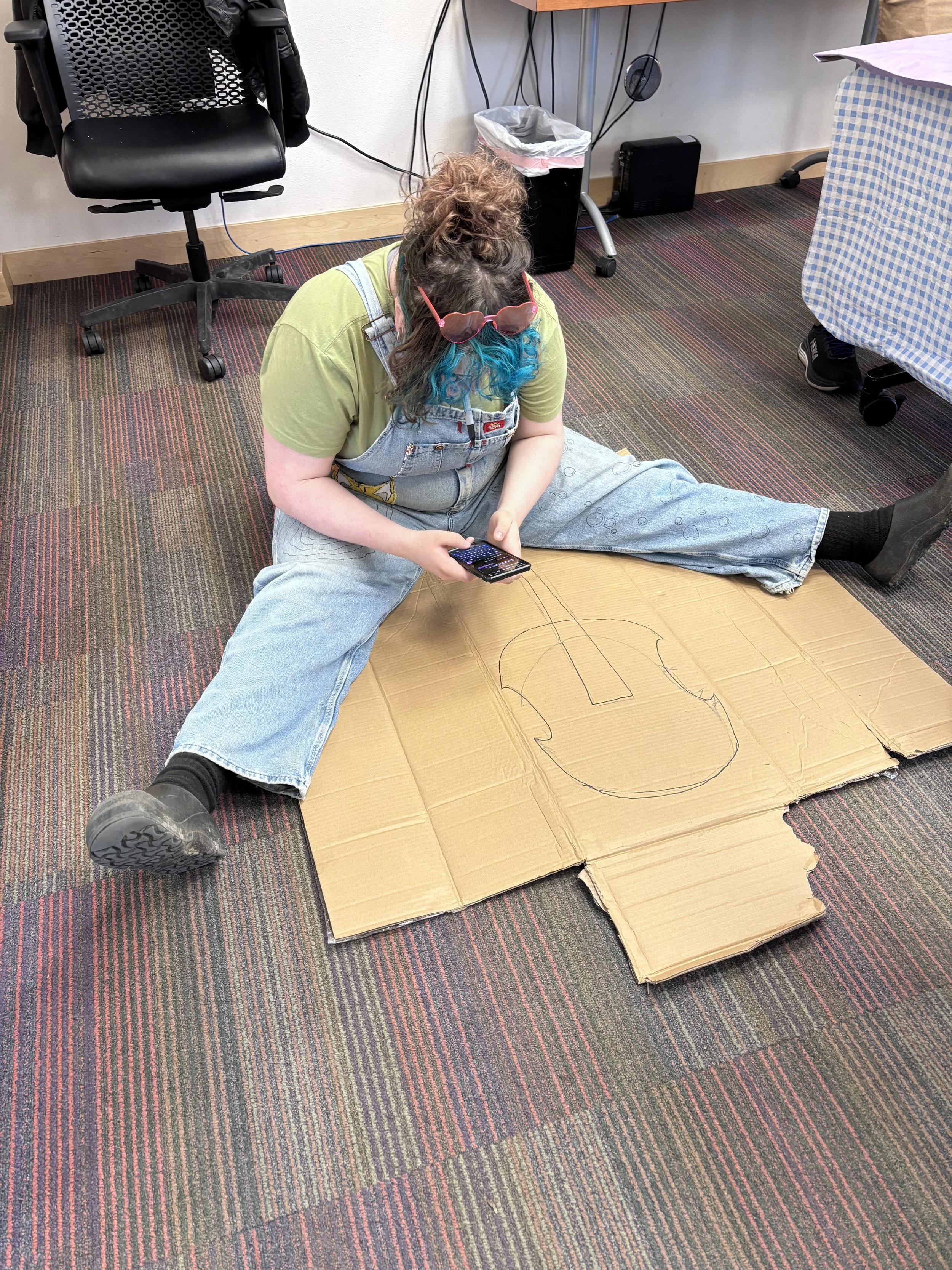 student making cardboard violin.jpeg