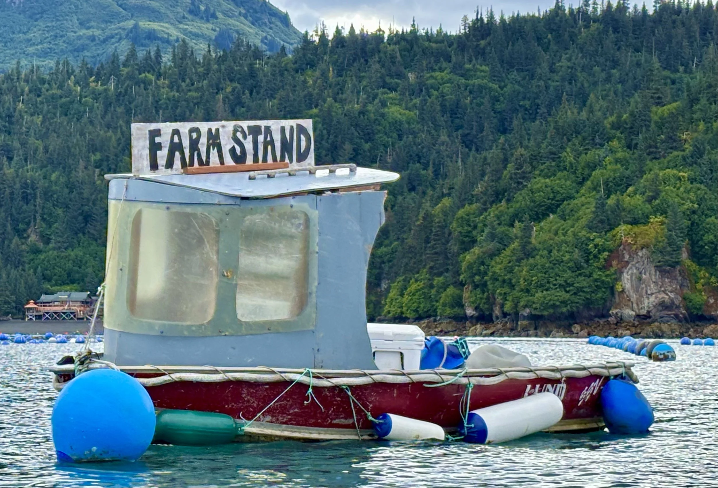 floating farm stand boat in bay.jpeg