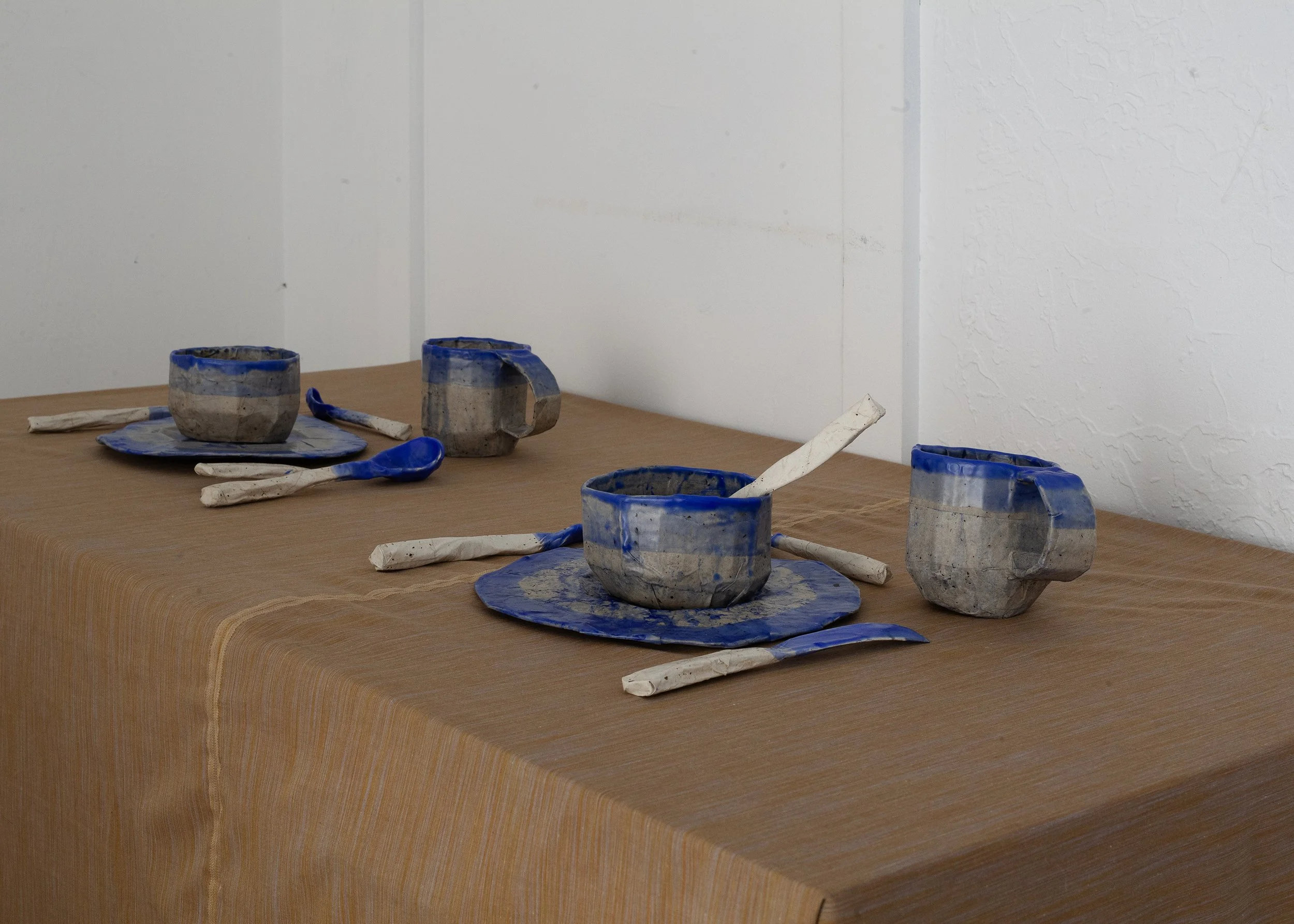   Dishes , 2025, cardboard, papier-mâché, beeswax, ultramarine pigment, dimensions variable 