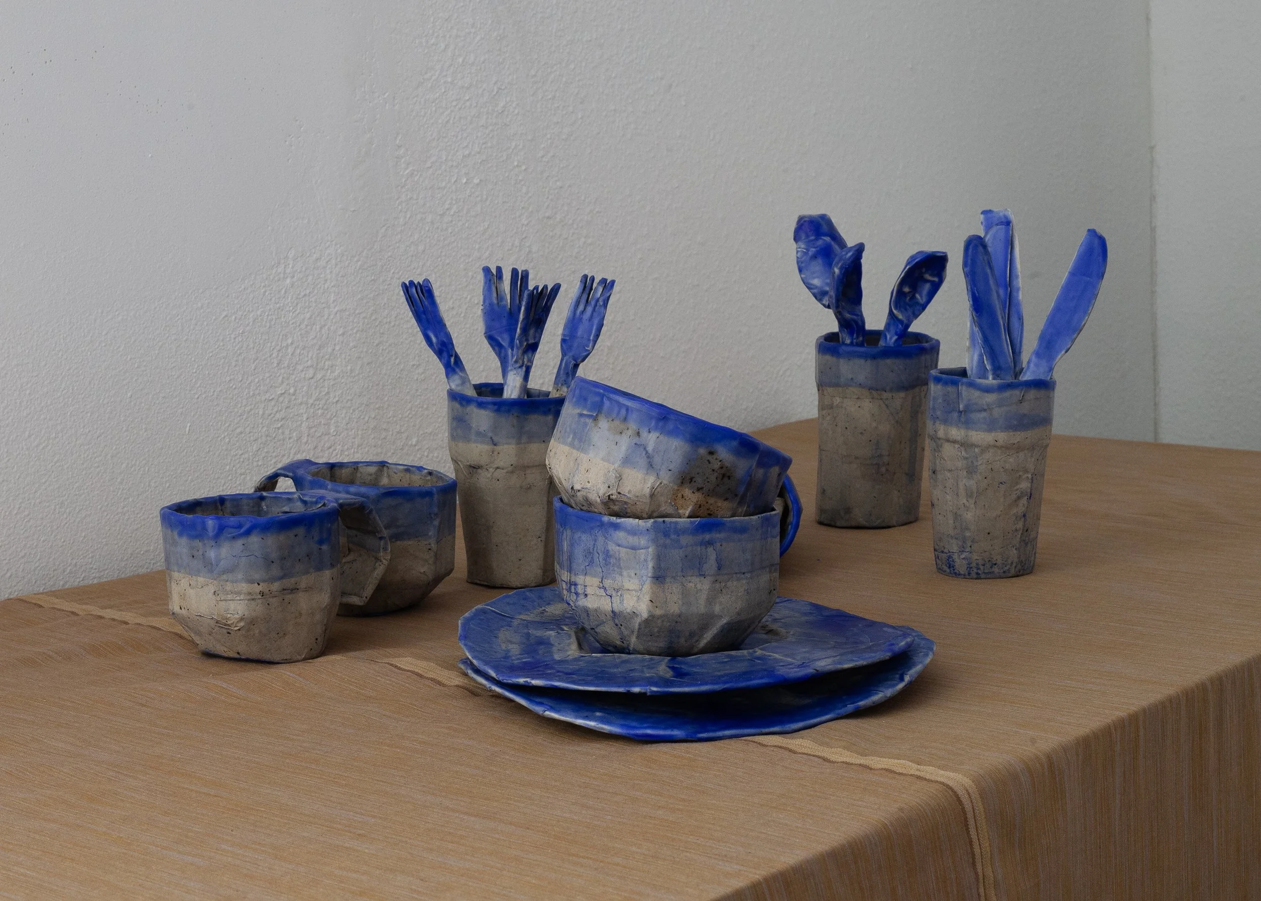   Dishes , 2025, cardboard, papier-mâché, beeswax, ultramarine pigment, dimensions variable 