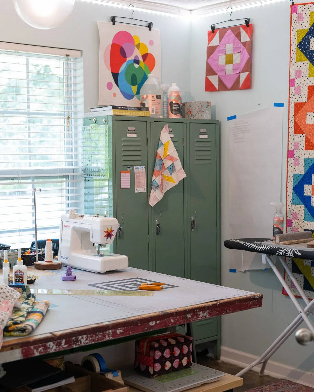 Welcome to the room where it all happens &mdash; color, chaos, and (most days) at least one finished block by the end of it.

A few things worth pointing out if you're peeking around:
That sticker on my machine is my own logo &mdash; I handed these o