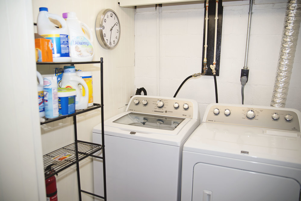 Clean Laundry Room With Added Ikea Storage And Clock