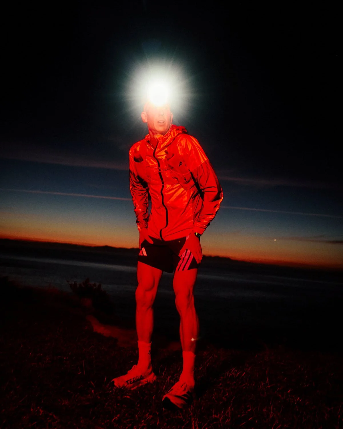 Ultra trail runner Dan Jones at dusk wearing headlamp, athlete photography for Adidas and Fenix