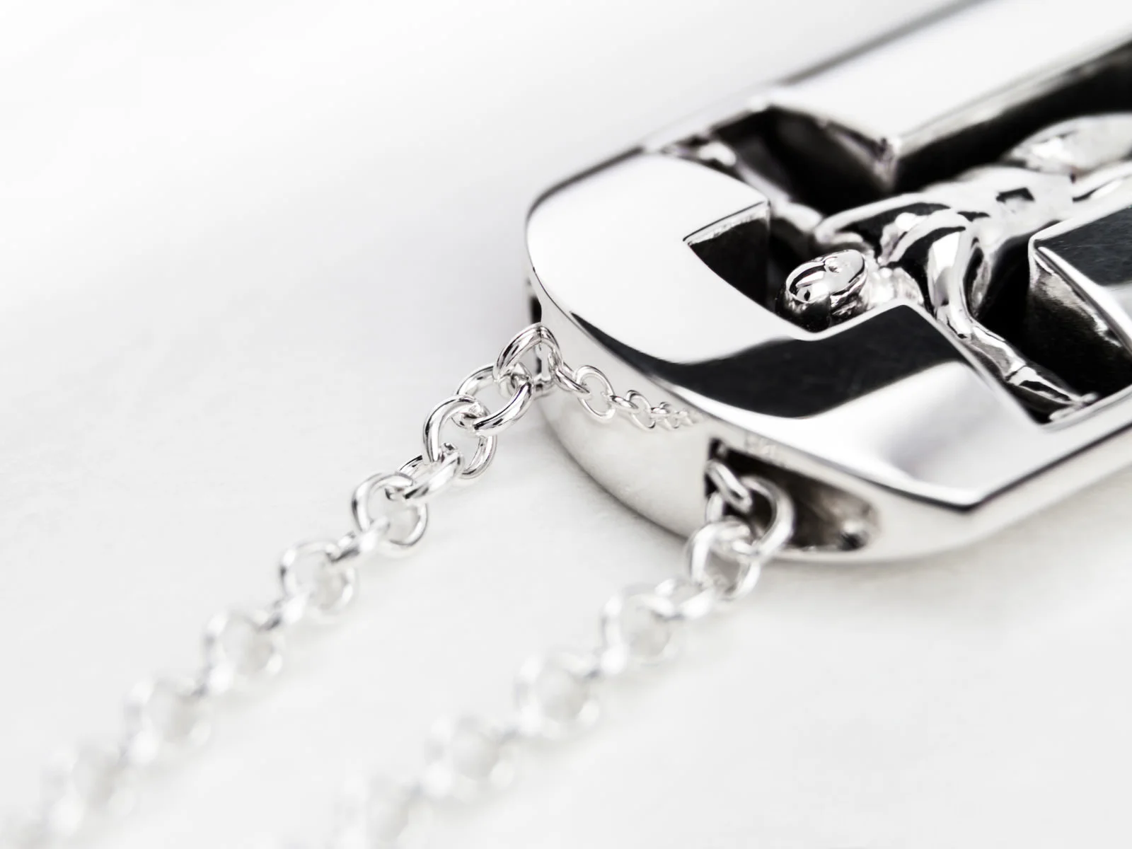 The ManTag stirling silver pendant with a man in a cross-pose standing in a recess military tag shape
