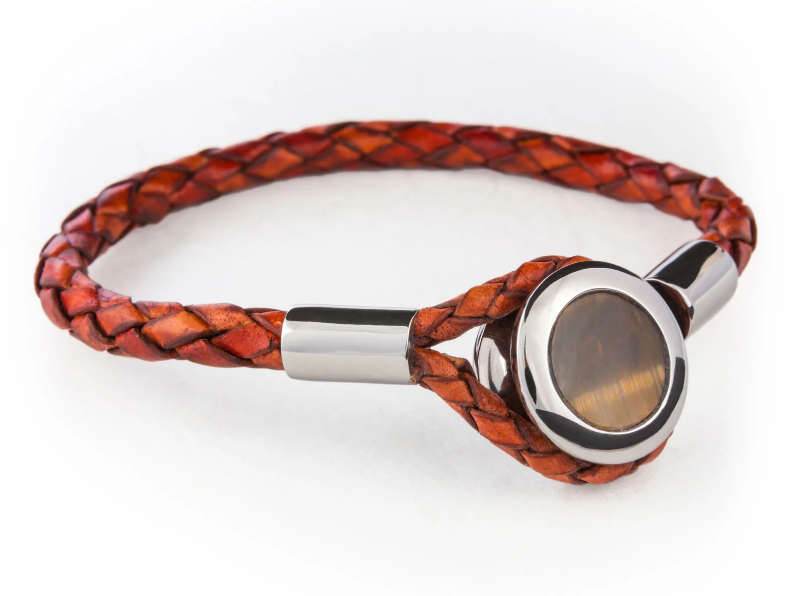 The button bracelet with a circular Tiger's eye gemstone embedded into a button shaped Ruthenium plated piece