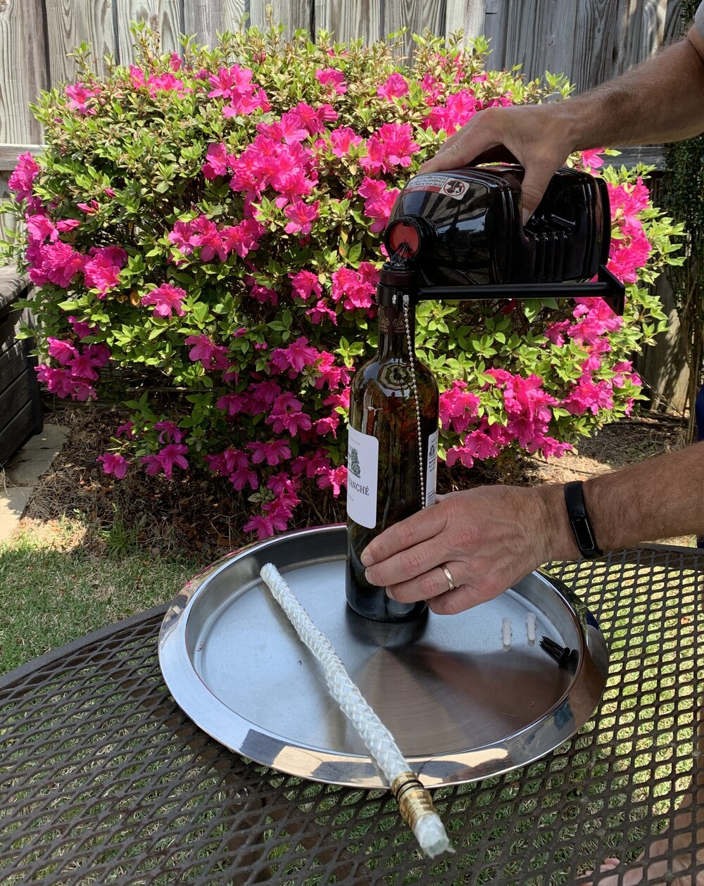 Pour citronella into wine tiki torch.jpg