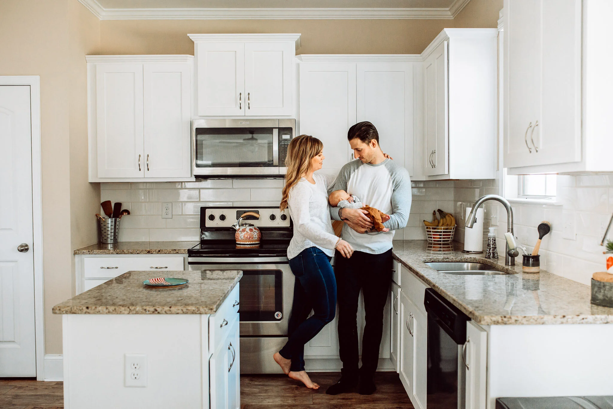 Family in kitchen white cabinets
