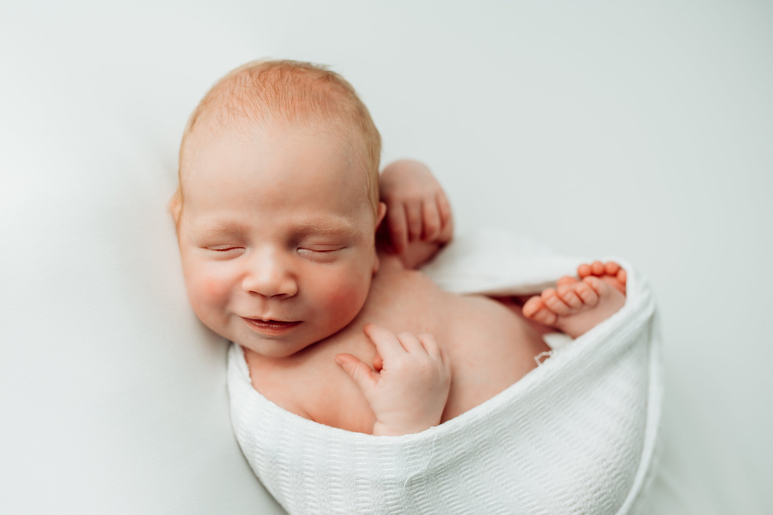 Newborn baby smiles while sleeping