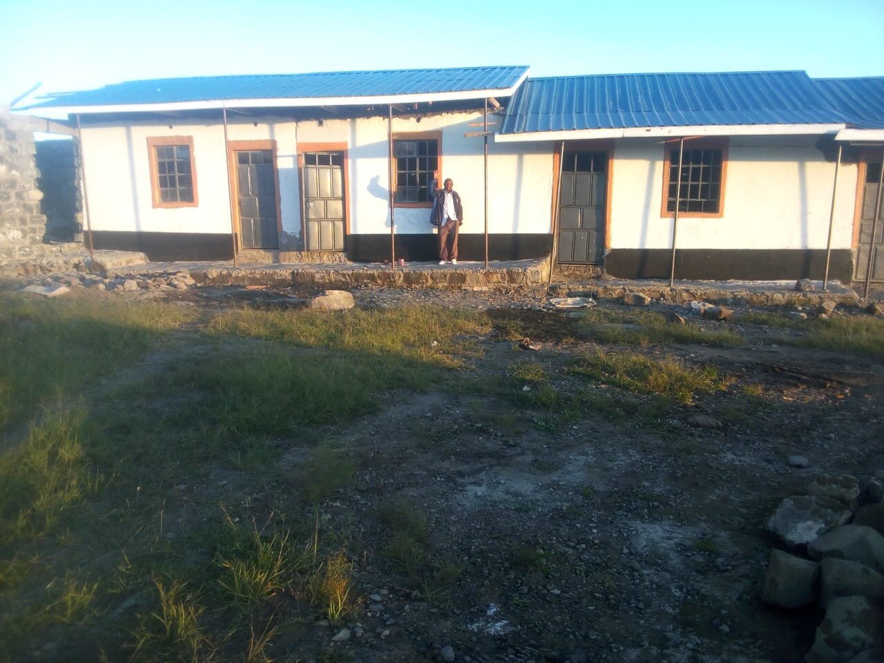 Peter in front of the new classrooms