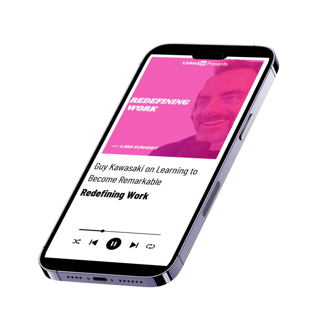 Smartphone displaying a podcast episode titled 'Guy Kawasaki on Learning to Become Remarkable' from 'Redefining Work' by Lars Schmidt, with a pink graphic featuring a smiling man's face.