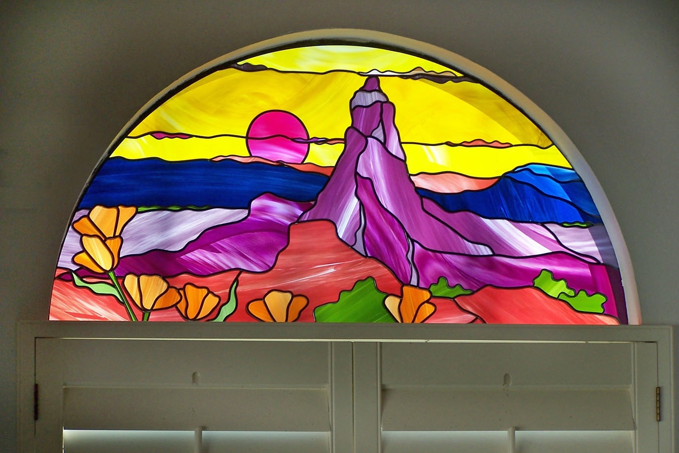  This half round transom is an Arizona desert sunset inspired placed in a home in Fallbrook. 