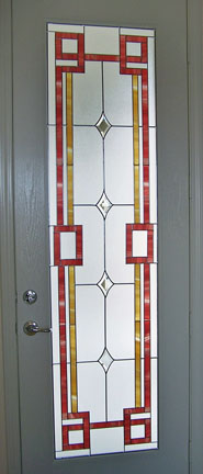  A Riverside home hosts this patio door insert. It is a geometric design in stained glass overlay with a strong red border. It is on one solid piece of tampered glass 