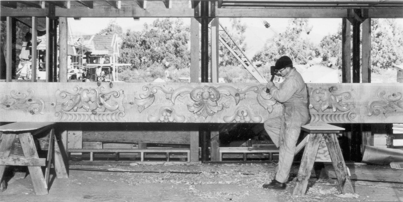 Master carver at work on one of the Inn's decorative beams