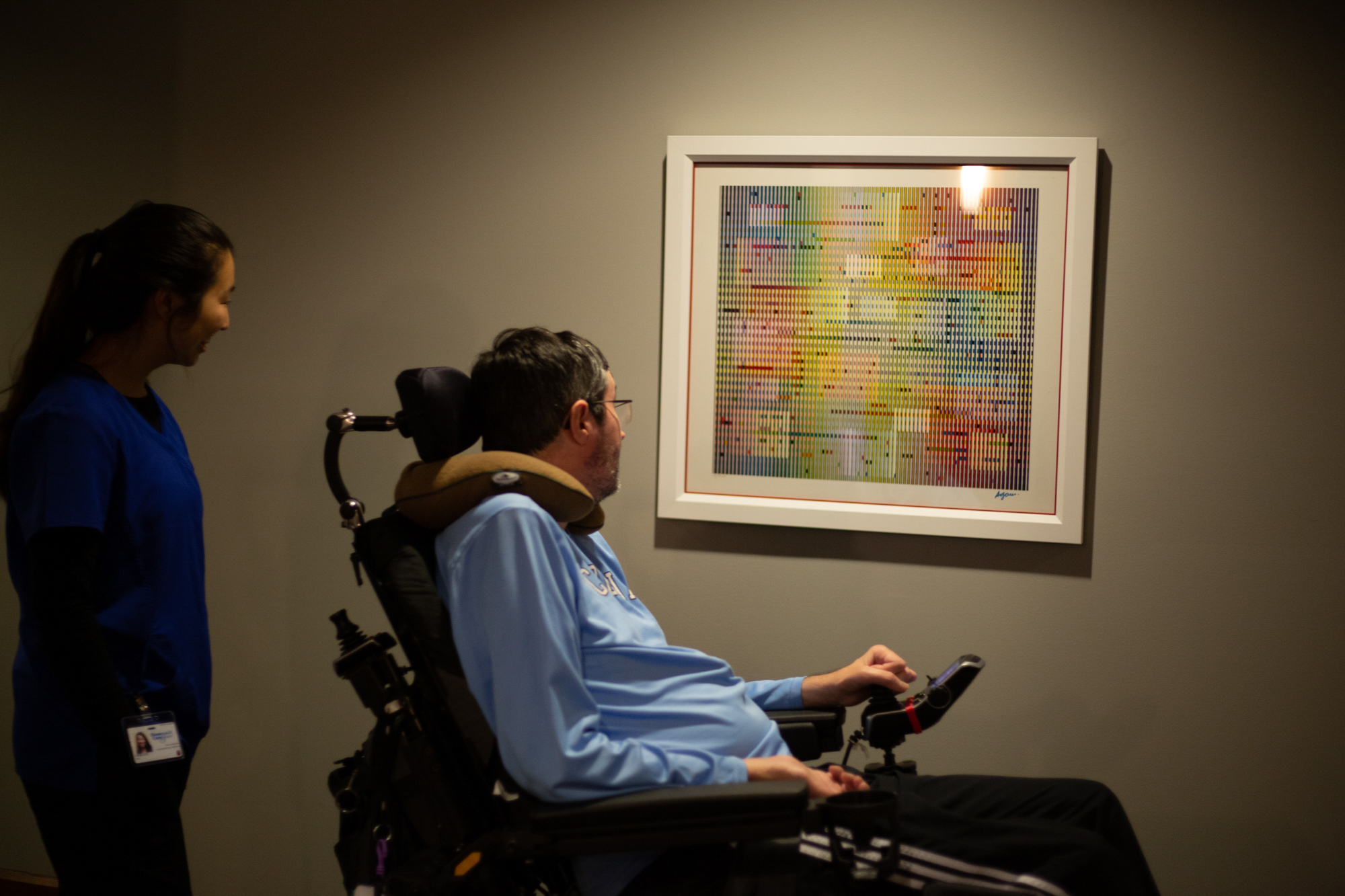  Irene Zhu, a UNC Chapel Hill senior planning on going to school to be a physician’s assistant, walks with Dr. Ross through the floors of his apartment complex on the evening of Oct. 25. &nbsp;On every floor of the apartment, the walls are filled wit