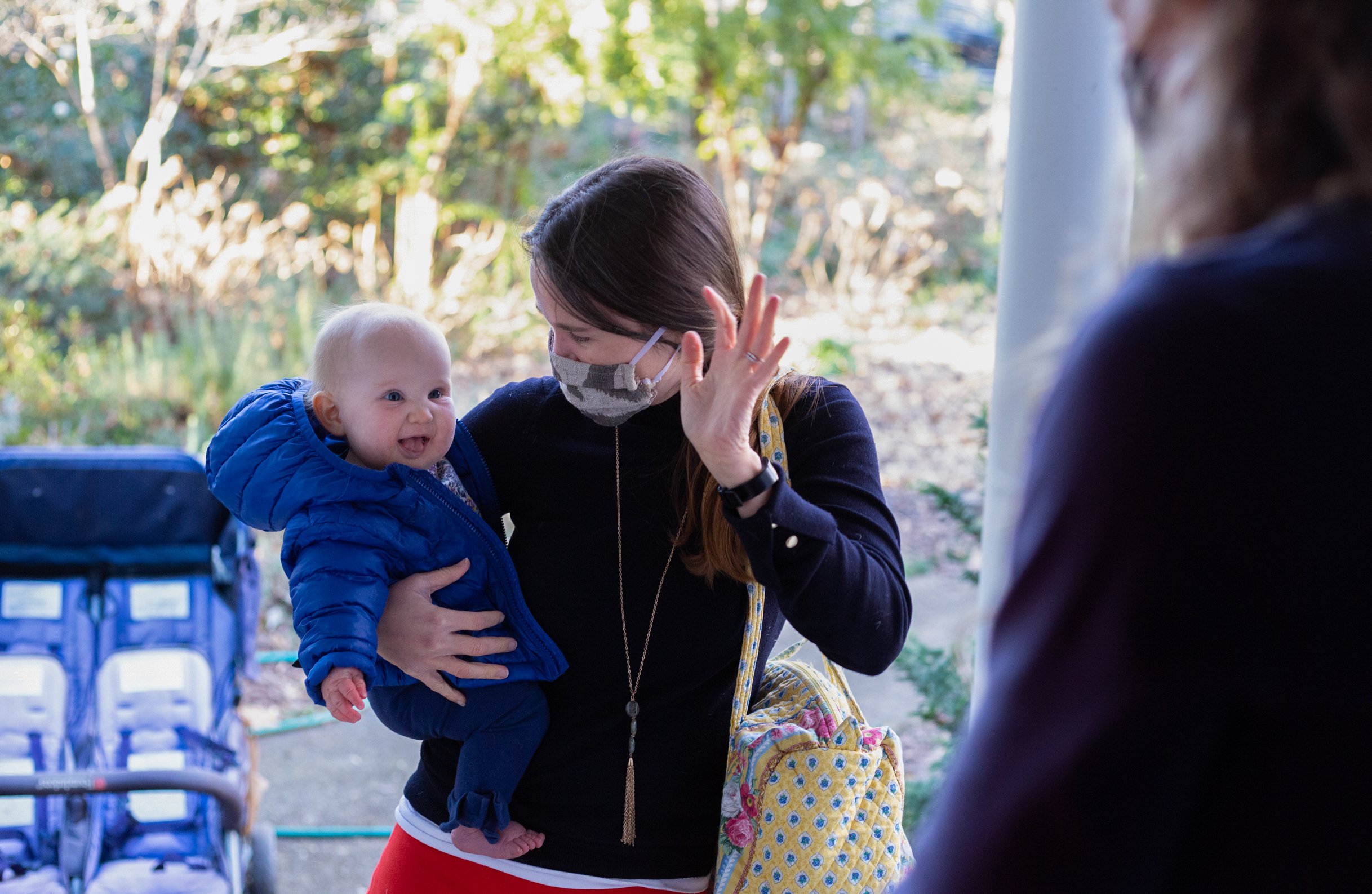  Sarah Haverland waves hello as she drops off her daughter, Elizabeth, at Tobin’s child care on Jan. 29, 2021. The work day begins. 