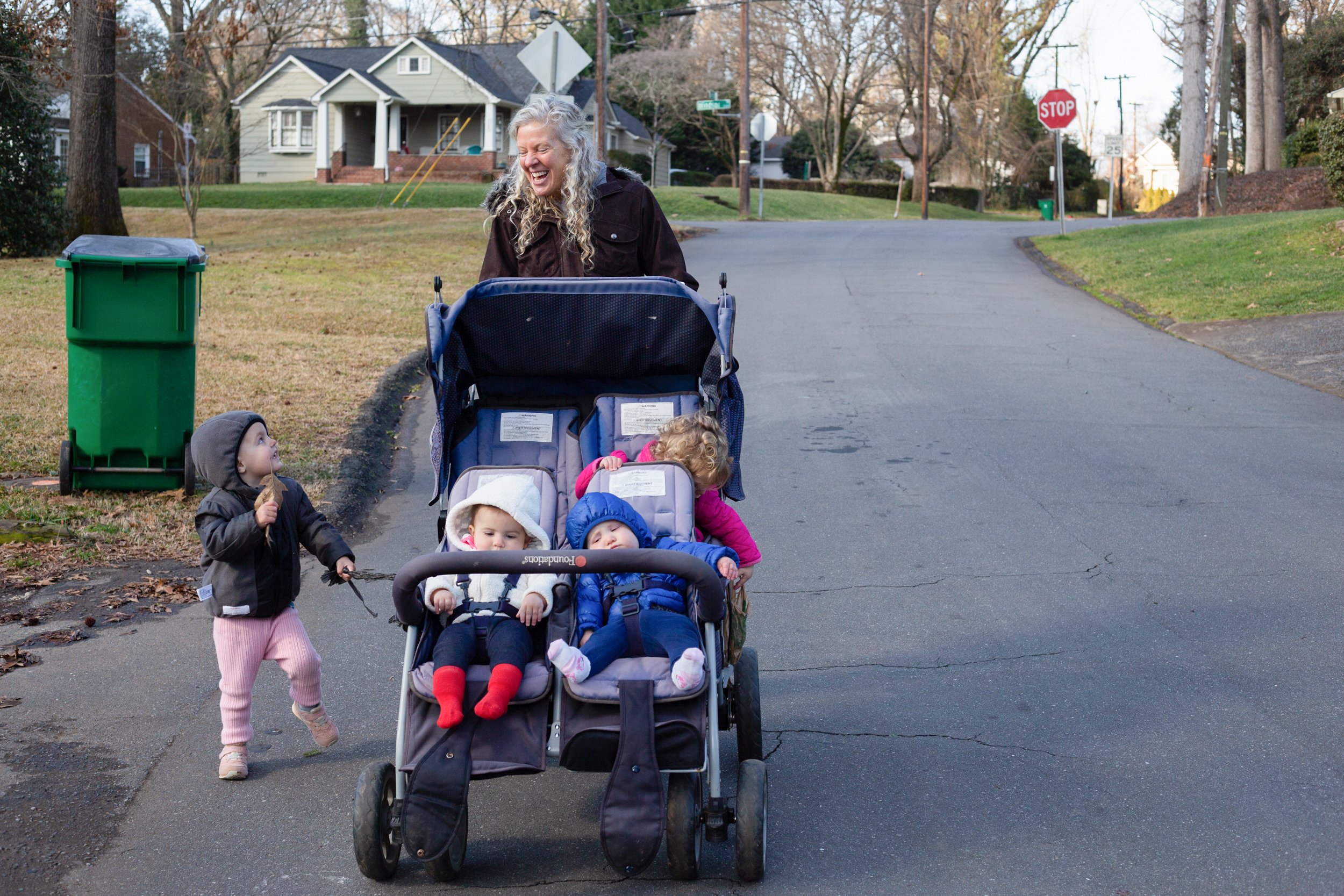  Tobin laughs at Larkin Flanagan, one of the children in her child care, while she goes on their daily walk.  Macy Harrison, Nellie Pfeiffer, and Elizabeth Haverland sit in the stroller.  She usually either takes them to a playground or to see someth