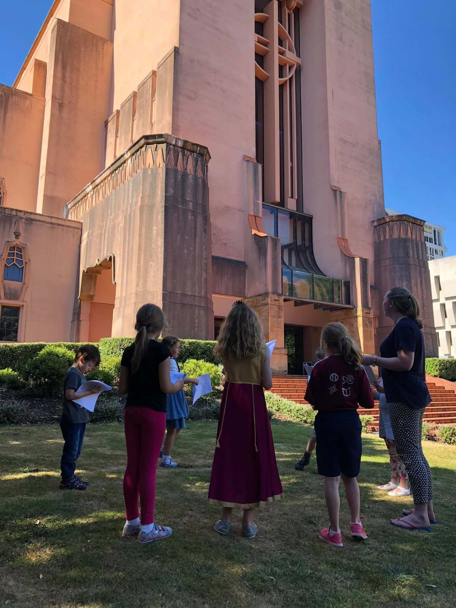 The children's choir rehearsing outside on a fine day