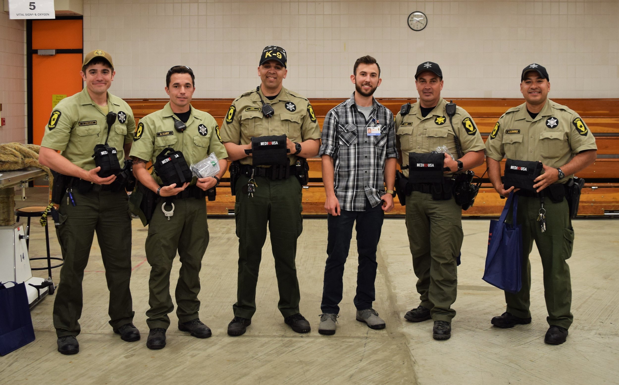 Members of the Illinois State Police K9 Unit with their donated trauma kits. 