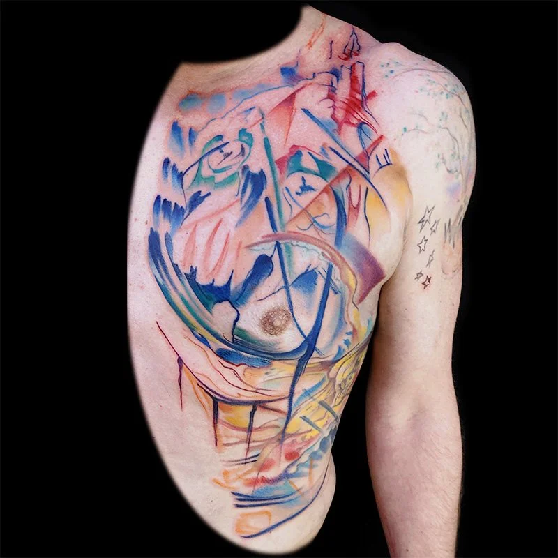 An abstract tatoo created by Zack Woods of Spokane, Washington.  It features brush strokes, ink, splatters and swirls around a mans chest and rib cage.  Its a color tattoo with lots of vibrancy.