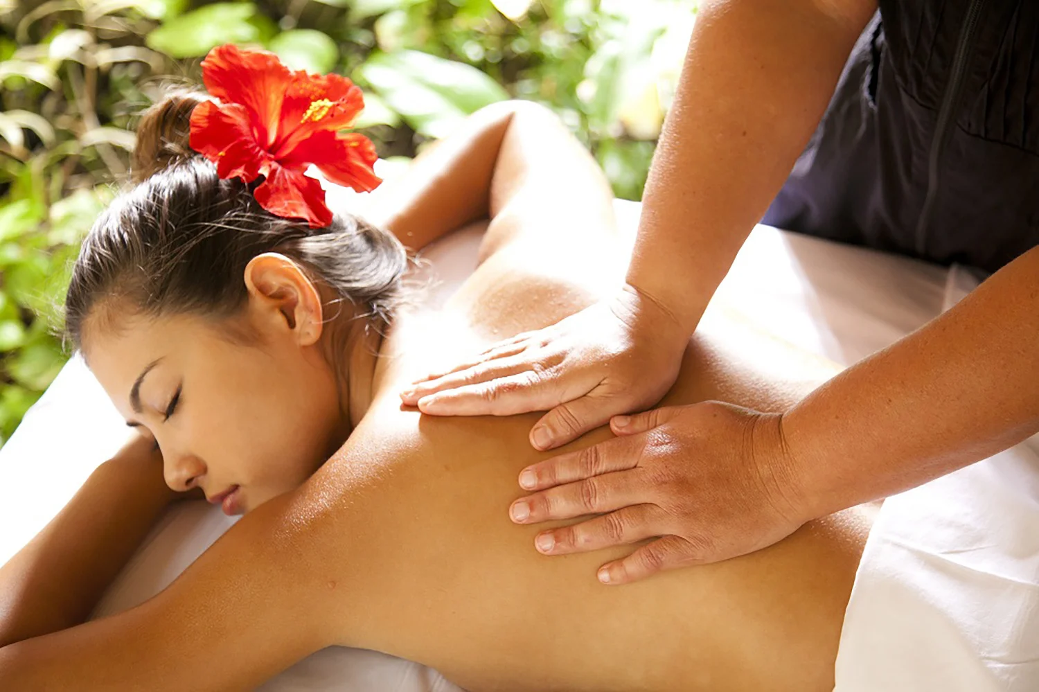 A guest gets a massage in the garden cabana.