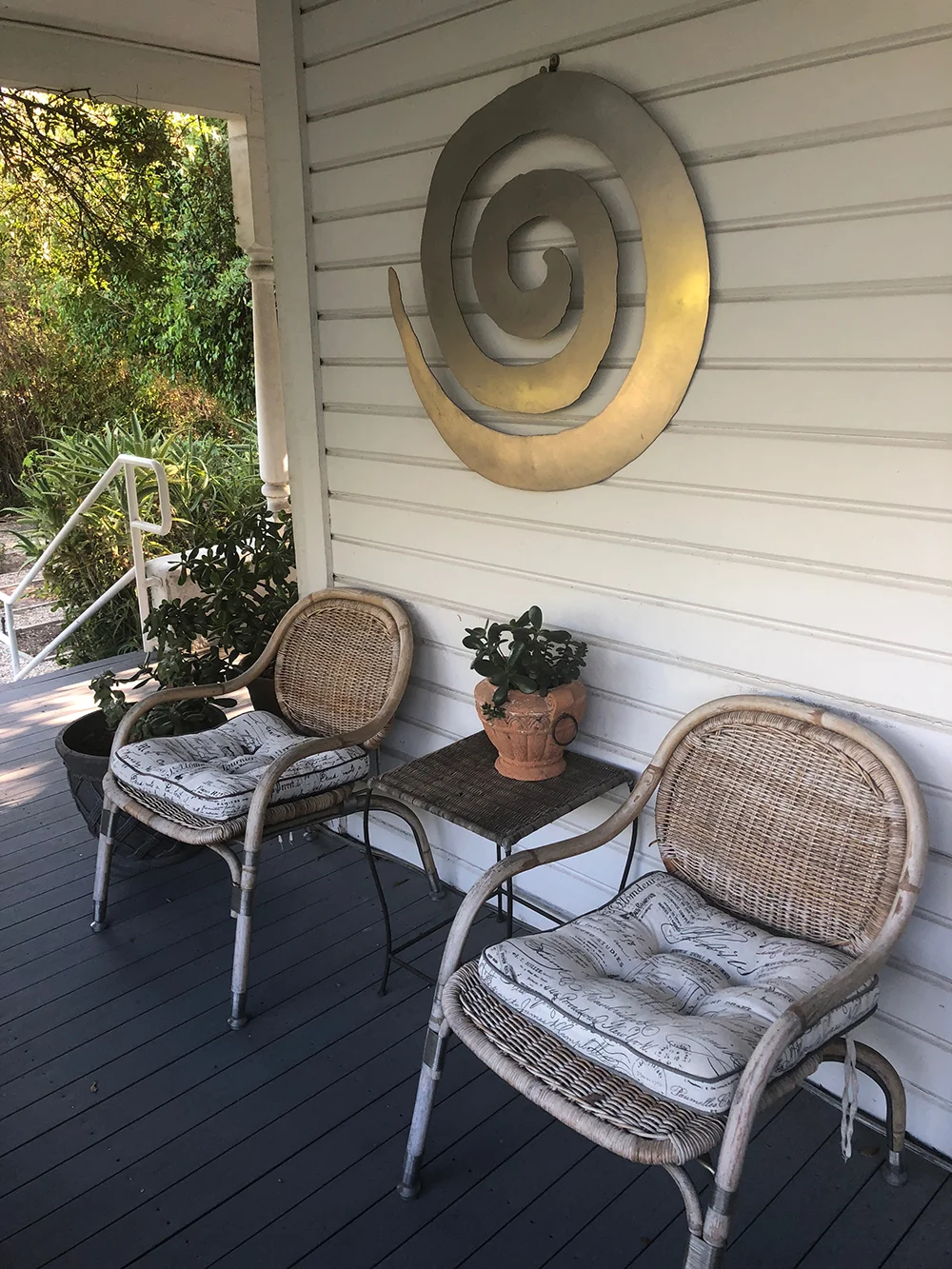 The wide, wrap-around porch offers additional comfortable seating for guests.