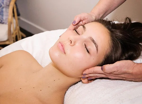 A guest receives a facial at Body Essentials.