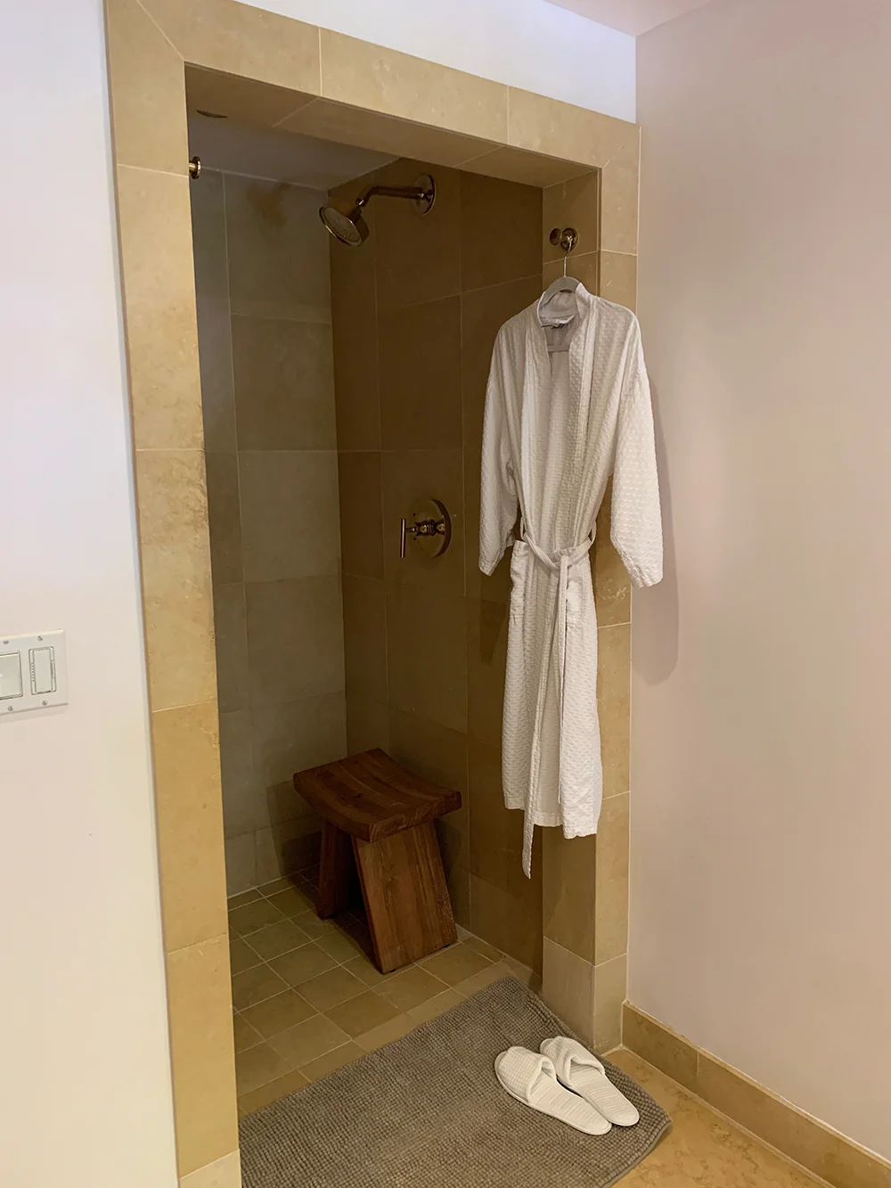 A private shower with robe and slippers.