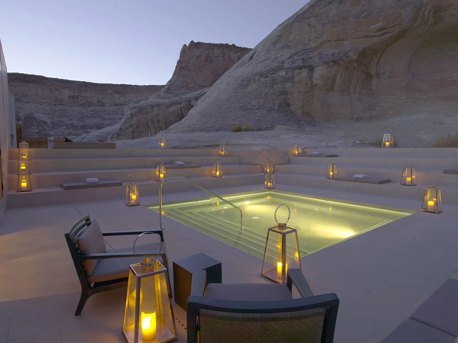 The stone-lined step pool with desert views offers cushioned seating and temperature-controlled water.