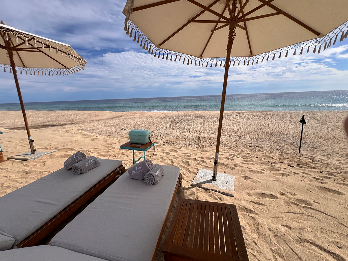 Beach lounge chairs and umbrellas on the beach.