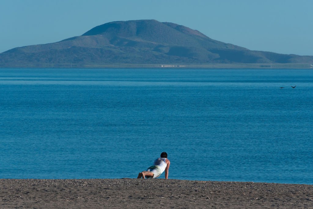 A man practices yoga on the beach in Loreto. [Image courtesy of Baja California Sur Tourism/photography by Nea Serrano]