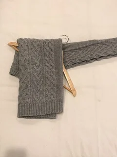 - Fold body of sweater over hanger