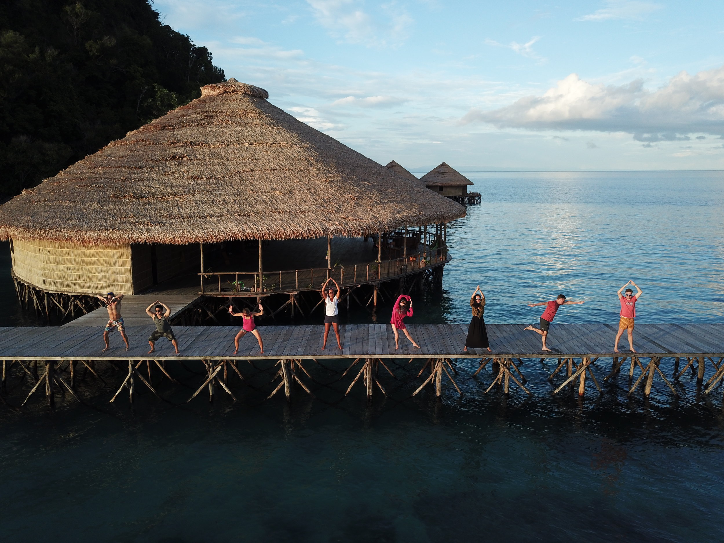 Raja Ampat - Yoga on the jetti - Guests having fun at the MahaRaja Eco Dive Lodge