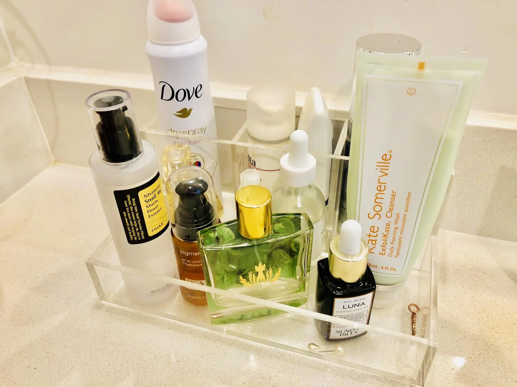 #SkinBabe Nikki Burdine's sink arrangement with her every day products: Luna Sleeping Night Oil, Kate Somerville Exfolikate cleaners, Elta sunscreen and Snail 96 mucin for spot treatment.