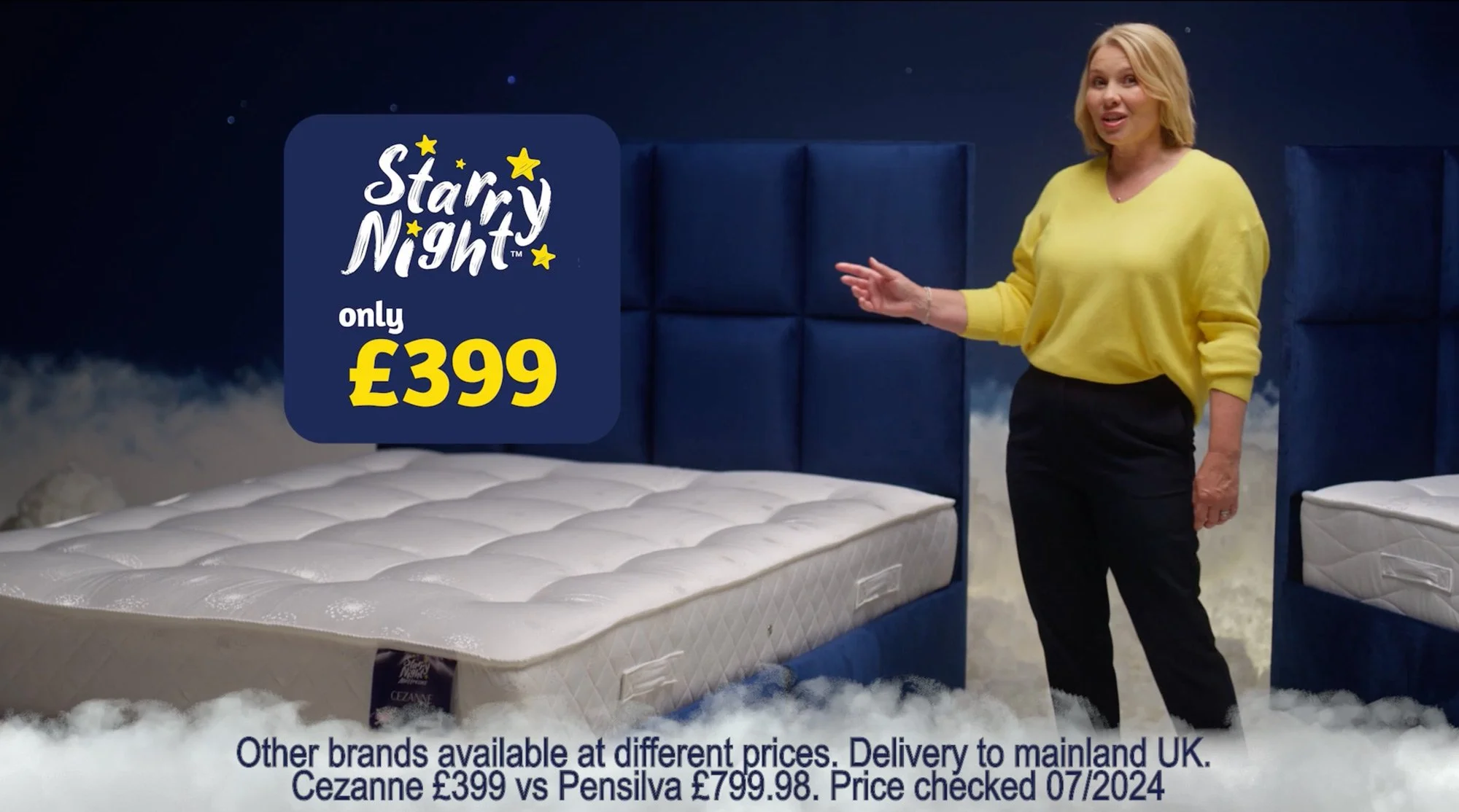 A woman in a yellow sweater points at a mattress with a price tag of 399 pounds in a setting with blue cushioned walls and cloud-like flooring, promoting a sale.