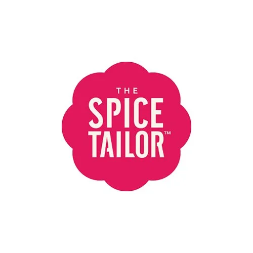 Logo for The Spice Tailor with a pink flower-shaped background and white text.