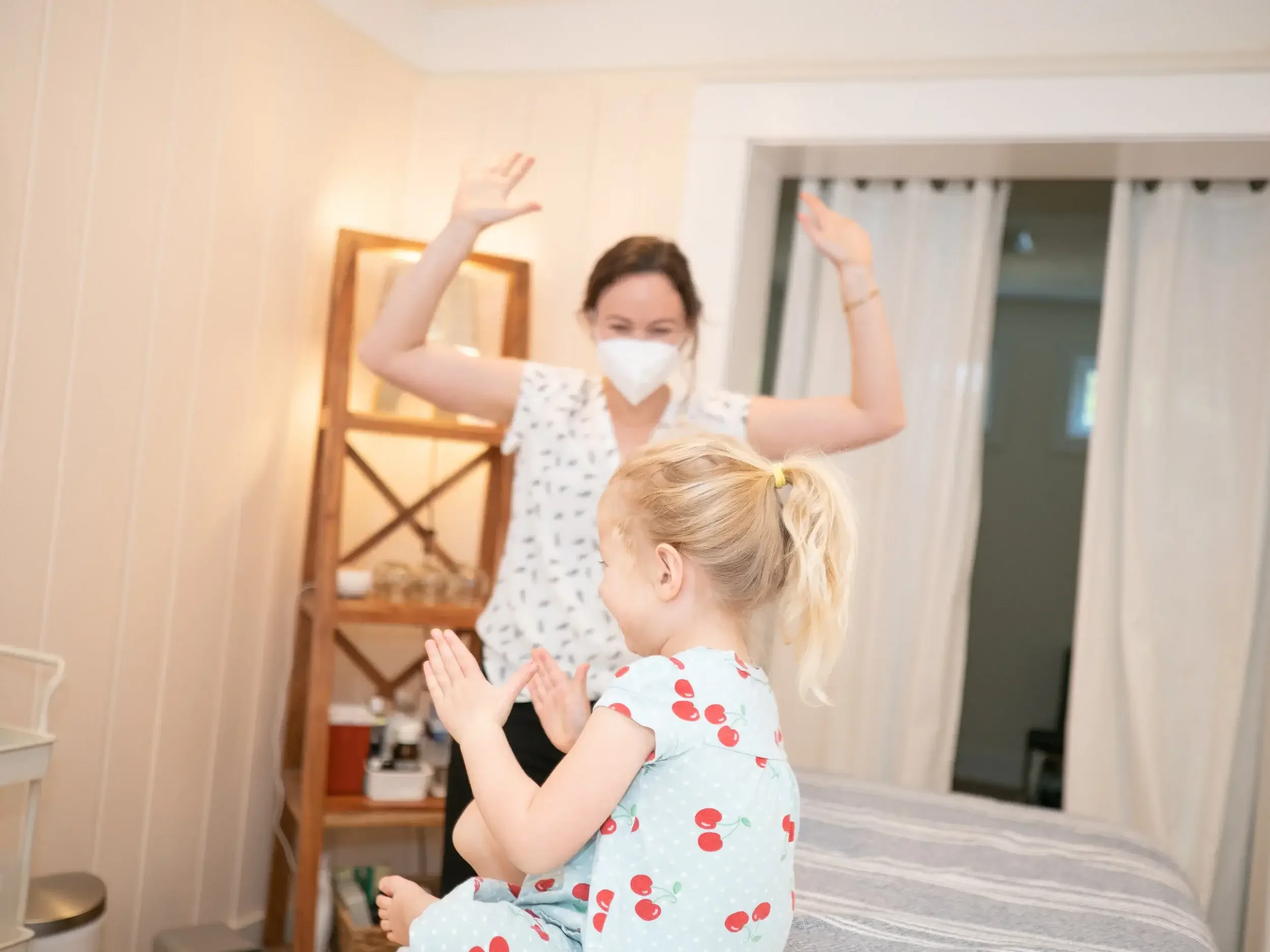 Lauren Becker interacting with little girl during pediatric acupuncture session