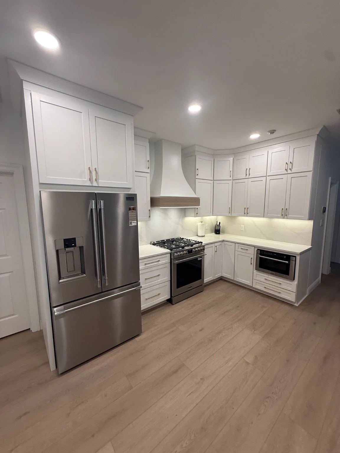 Custom white kitchen renovation completed by All Service Painting and Construction in Mobile Alabama