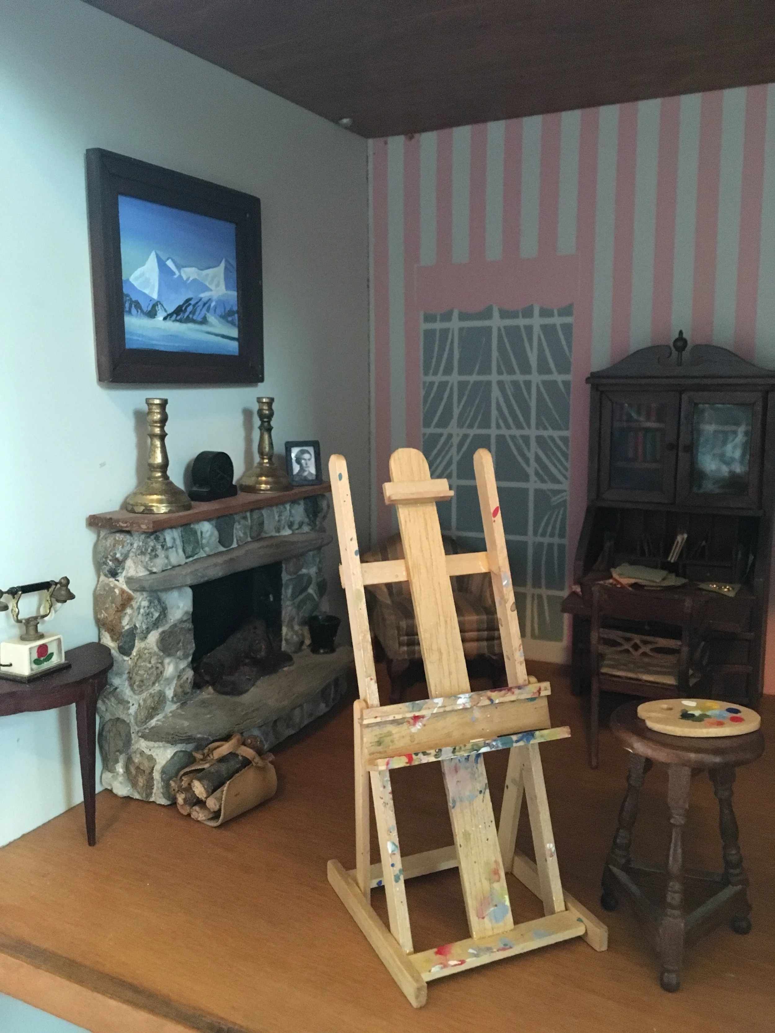 Wooden Easel and Palette<br>Framed photo on fireplace mantel<br>Framed Rockwell Kent replica on wall<br>For My Dollhouse<br>2017 