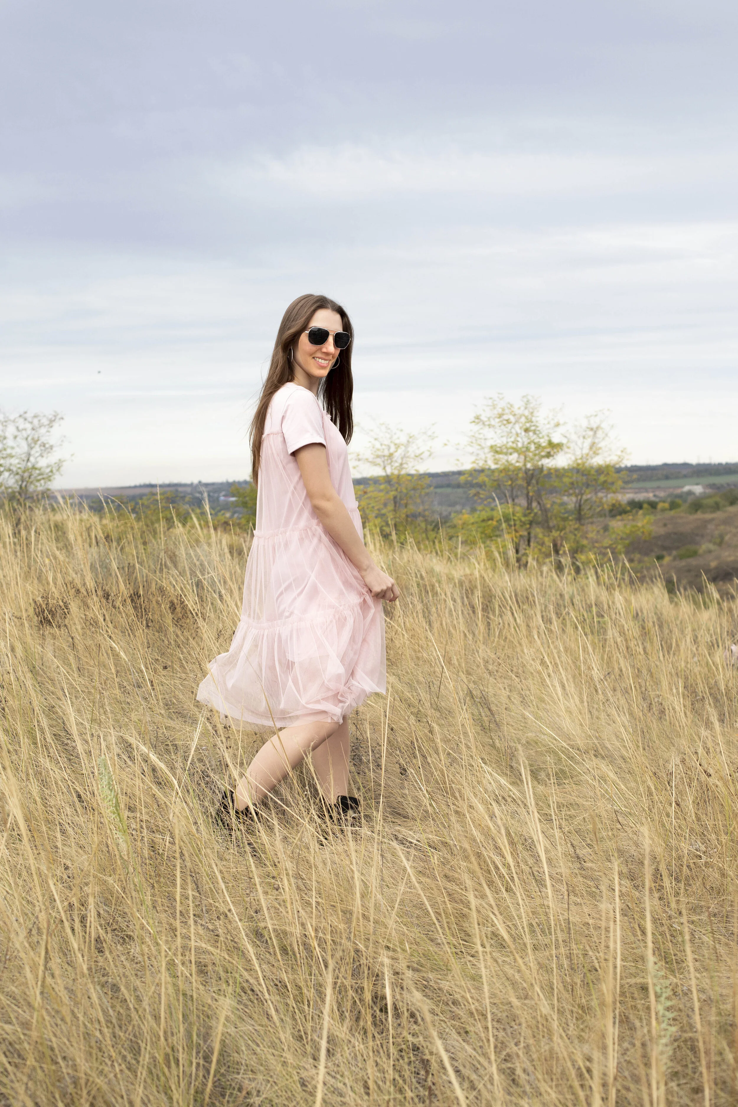 Girl in a delicate dress walks in nature