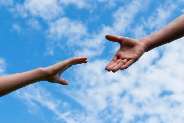 two-hands-reach-out-sky-clouds.jpg