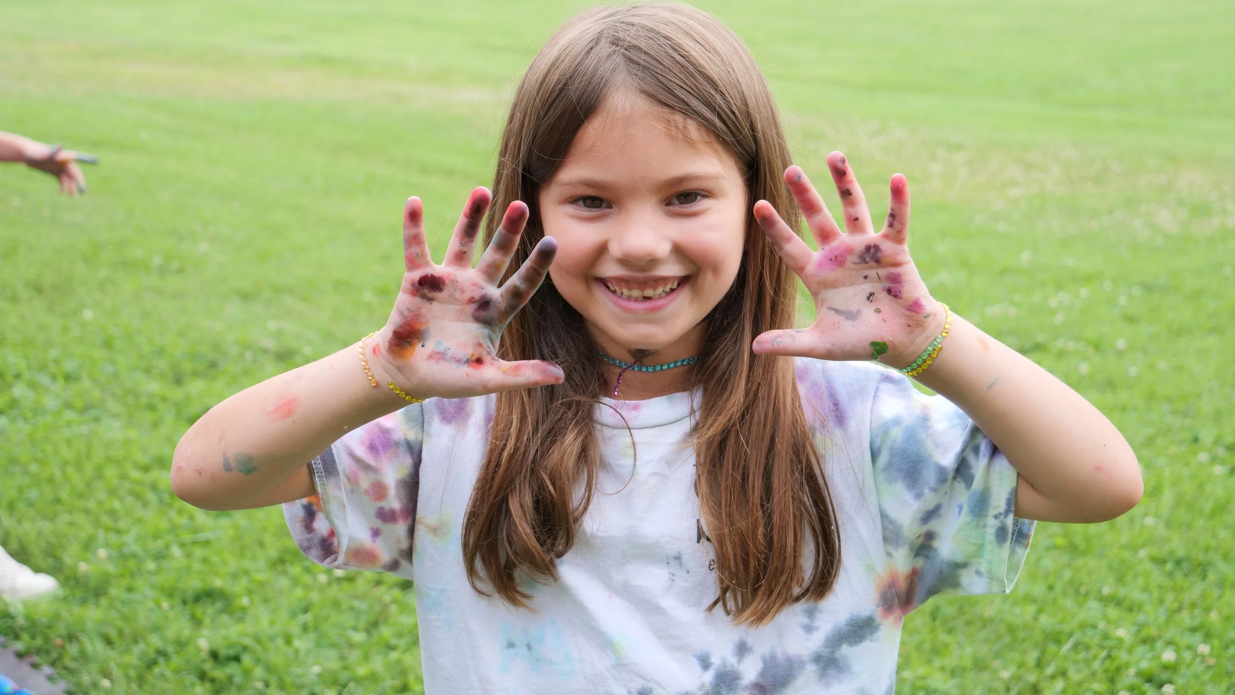 Camp Walden camper showing colorful painted hands