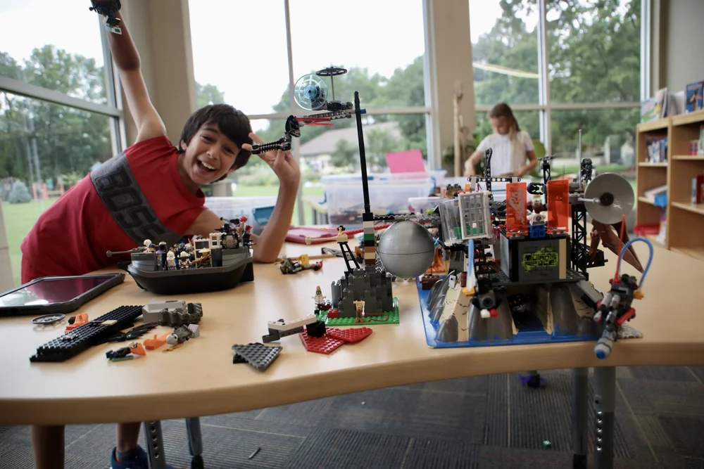 Camper proudly showing a creative LEGO construction
