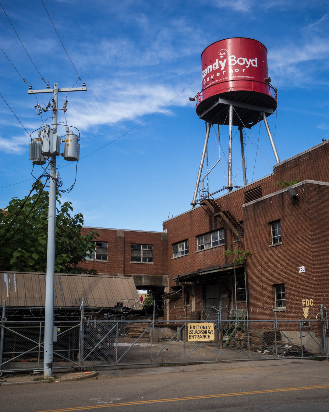 In this image, the swaths of browns on the bottom and blue on top create a balance. That balance is then broken by the water tower which adds interest to the photograph.